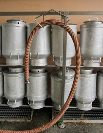 Several milk churns in a row at the dairyの写真素材