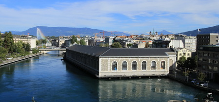 Rhone river, Batiment des Forces Motrices and fountain at Geneva, Switzerlandの写真素材