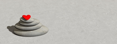 Small red heart upon white stones in balance on grey groundの写真素材