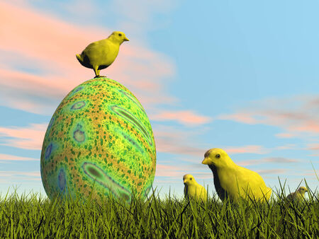 Yellow cute chicks around colorful easter egg in the grass by beautiful day