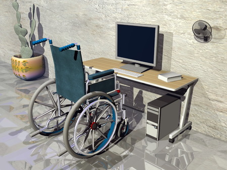One wheelchair in front of office desk with computerの写真素材