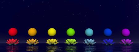 Colorful spheres for chakras upon beautiful lily flowers by nightの写真素材