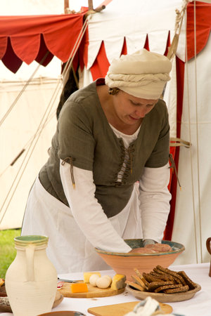 HORB AM NECKAR, GERMANY. 18 JUNE 2016. A medieval market on joust. Woman preparing dough.のeditorial素材