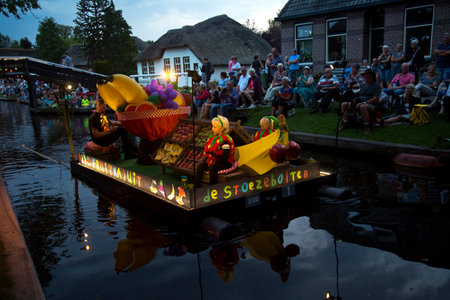 GIETHOORN, THE NETHERLANDS, 31 AUGUST 2019. Gondola parade on the village canal in Giethoorn,...