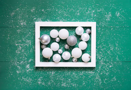 Beautiful festive composition of white and gray balloons with lie in white in a frame on a green...