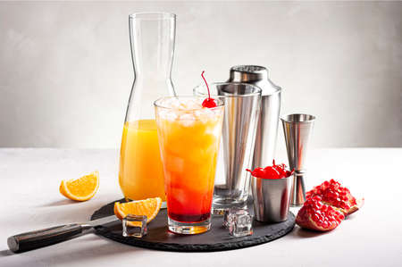The process of making an alcoholic cocktail Tequila Sunrise. Horizontal orientation, selective focus.の写真素材