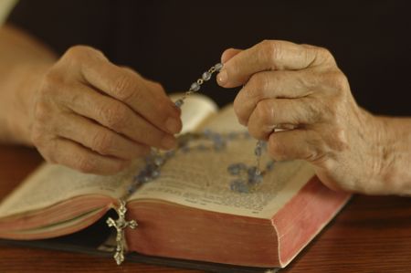 Elder woman's hands counting rosemary beads.の写真素材