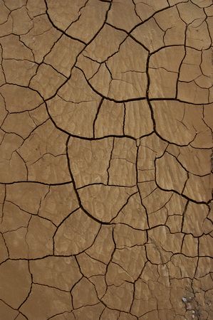 Geometrically descending cracked earth with lower image pebble accent.