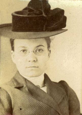 Vintage print of a young woman in a stylish hat. Circa 1910 print has scratches, artifacts, fading...