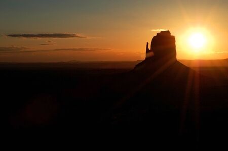 Silhouette of the classic Monument in Monument Valley with the rising sun.の写真素材