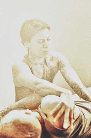 Thai yoga therapist working on her client  