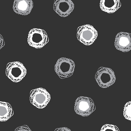 Monochrome brush drawn dots seamless vector pattern. White and grey grungy rough circles on black backdrop. Round shapes ornament.のイラスト素材