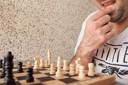 Pensive boy playing chessの写真素材