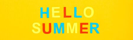 Hello summer. The inscription of colored carved letters on a yellow cardboard. Top view. Web bannerの写真素材