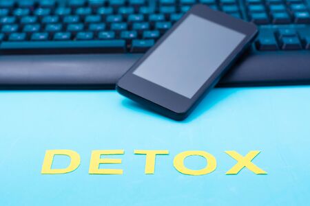 Digital detox concept. Word detox on a smartphone and keyboard background. Gadget addictionの写真素材