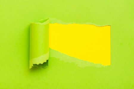 Torn green paper with space for text with yellow backgroundの写真素材