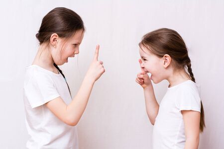 Two girls sisters strongly quarrel with each otherの写真素材