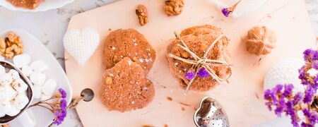 Homemade chocolate chip cookies with walnuts on the kitchen board. Table setting for breakfast. Top viewの写真素材