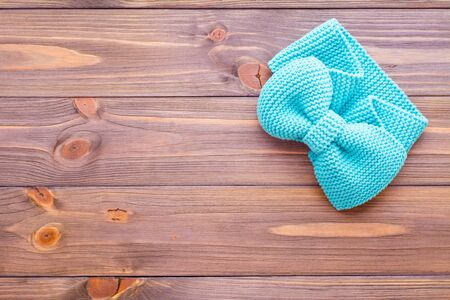 Knitted mint headband on a wooden background. Top viewの写真素材