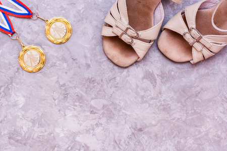 Two medals on the ribbon and shoes for sports ballroom dancing. Top viewの写真素材
