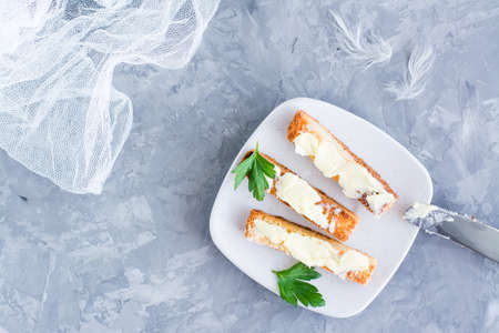 Fried toast with butter and parsley on a plate. Top viewの写真素材