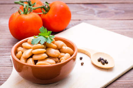 Cooked beans in tomato sauce in a bowl on the kitchen tableの写真素材