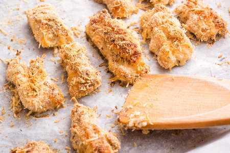 Homemade nuggets from chicken on a baking sheetの写真素材