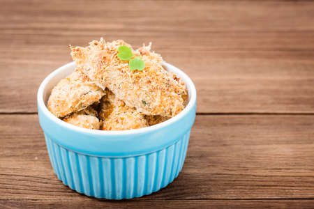 Homemade nuggets from chicken in a bowl on a wooden tableの写真素材