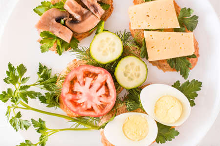 Tasty sandwiches on a plate and forks on a table. Top viewの写真素材
