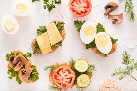 Tasty sandwiches and herbs on the table. Top viewの写真素材