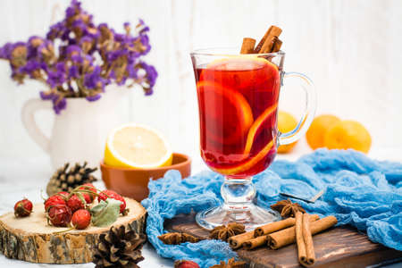 Hot tea with lemon and cinnamon in a glass. Winter warming drink