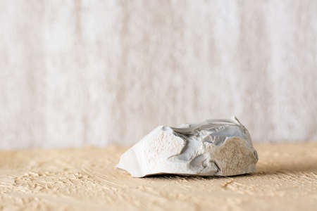 Natural stone on a beige textured plaster surface