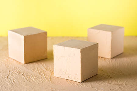 Mockup. Three textured cubes stand on a beige background