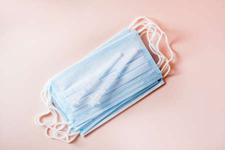 Vaccination and Immunization. Syringes lie on protective face masks. Top viewの写真素材