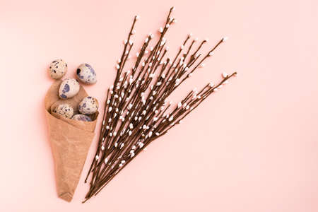 Happy Easter. Package with quail eggs and pussy willow bouquet on pink backgroundの写真素材