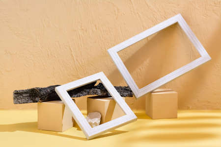 Modern abstract life style background: concrete, blank photo frames, stones and tree bark in the...