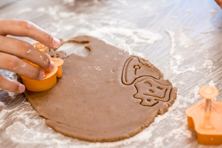 Preparing to celebrate halloween and preparing a treat. Hands are cut out with molds from rolled...