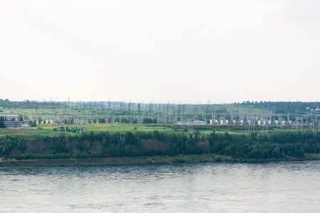 Switchgear on the lines of a hydroelectric power station on the river bank. Renewable alternative...
