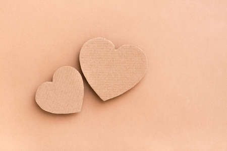 Dating concept. Two cardboard hearts together on a beige background. Top view. Valentine's dayの写真素材