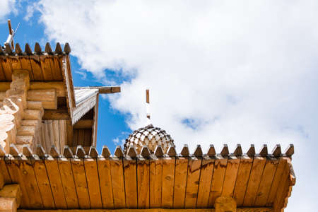 Part of the roof of an old wooden Orthodox church against the backdrop of a cloudy sky. Bottom viewの写真素材