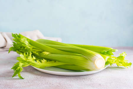 Fresh celery stalk on a plate on the table ready to eat. Vegetarian foodの写真素材