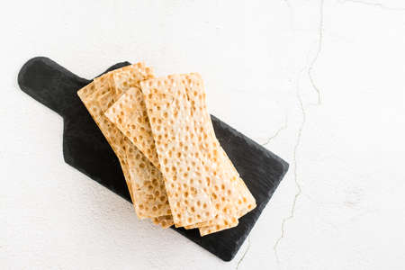 Thin crispy grain bread on slate on the table. Health food. top view
