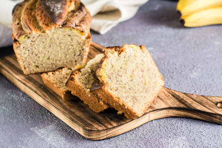 Sliced banana bread on a cutting board on the table. trendy dessert.の写真素材