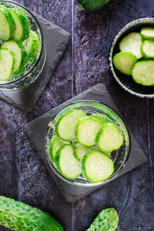 Cucumber mineral water in glasses on the table. Homemade antioxidant drinks. Top and vertical view