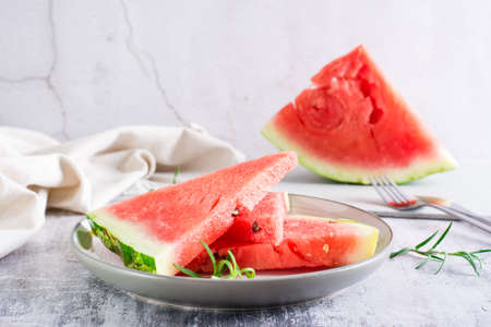 Pieces of ripe watermelon on a plate on the table. summer refreshment.