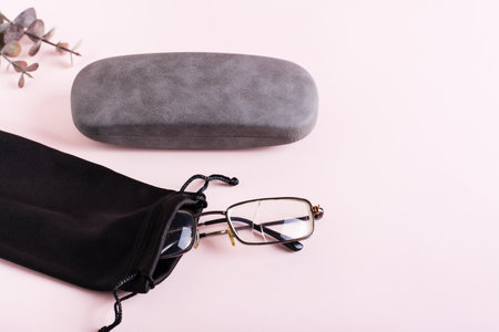 Broken glasses in a soft fabric case and a hard case next to it. The concept of careful storage of opticsの写真素材