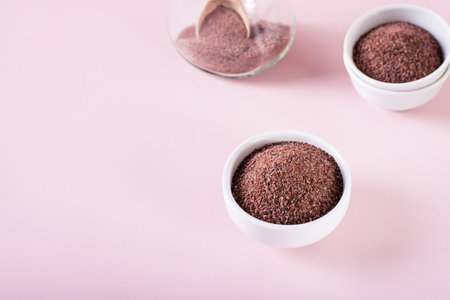 Black Himalayan rock salt kala namak in bowl on pink backgroundの写真素材
