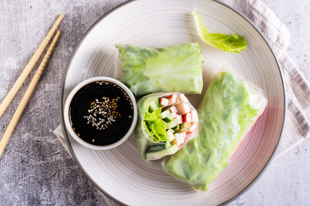 Fresh spring rolls with crab sticks, cucumber and lettuce. Vegetarian food. top view. close up