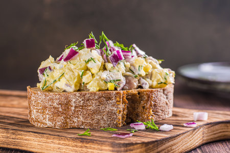 Close-up of rye bread sandwich with swedish salad on wooden boardの写真素材