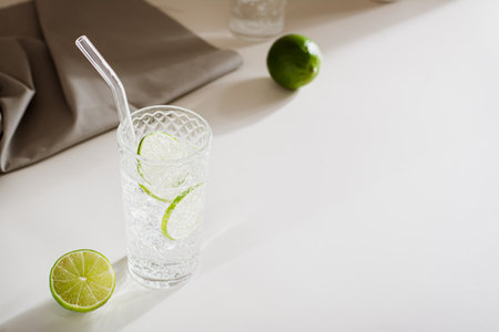 Hard seltzer with ice and lime in glasses on the tableの写真素材